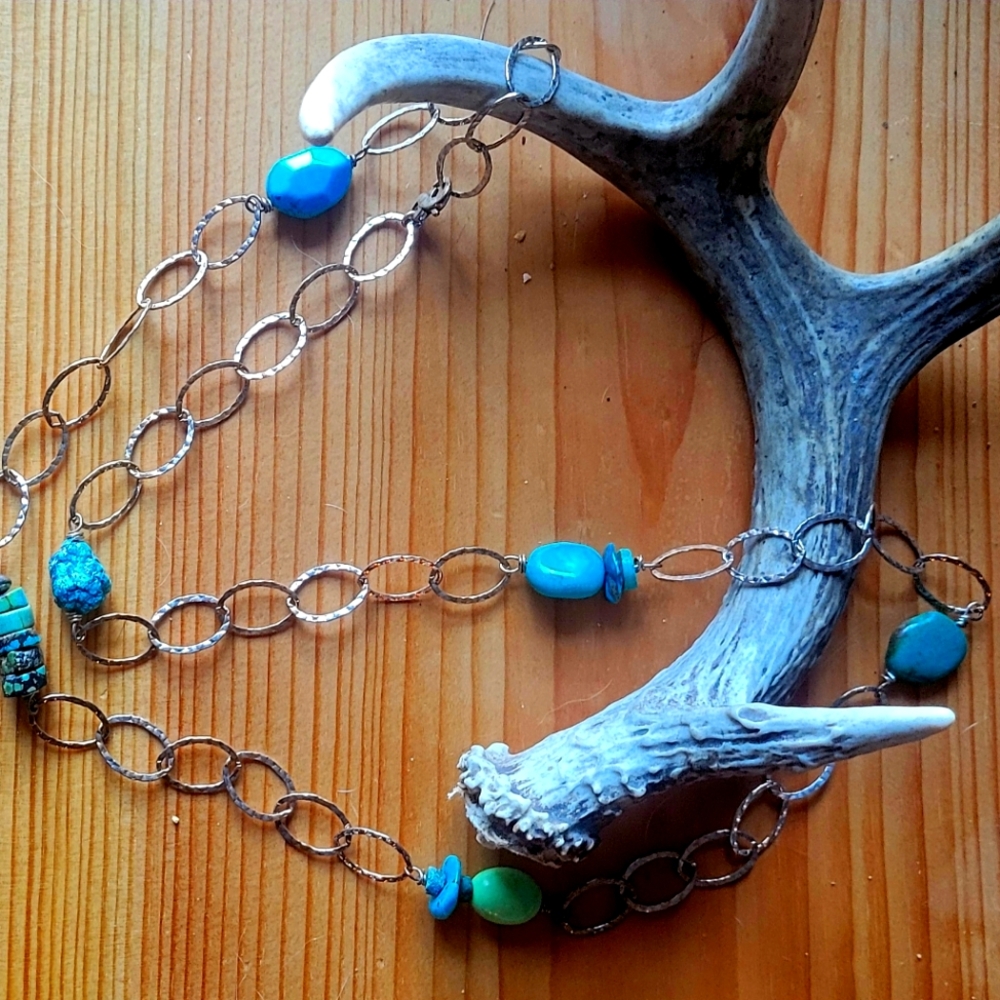 Long turquoise and silver necklace.